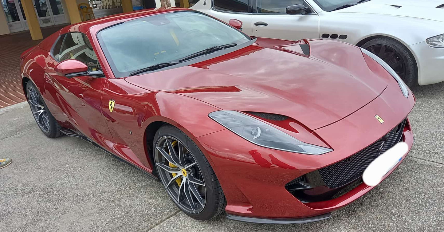2022 Ferrari 812 GTS in dark red with black interior, full side view.