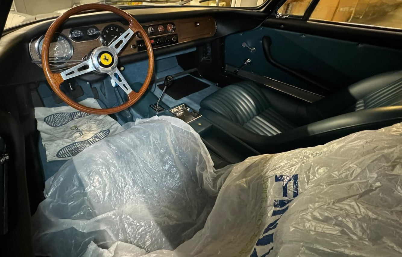 Interior of the 1966 Ferrari 275 GTB – Vintage black leather cockpit with classic Ferrari craftsmanship.