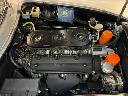 Engine bay of the 1966 Ferrari 275 GTB – Powerful V12 engine, meticulously maintained.