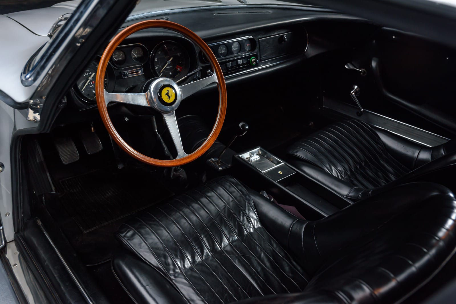 Interior of the 1967 Ferrari 275 GTB – Luxurious black leather cockpit with vintage Ferrari craftsmanship.