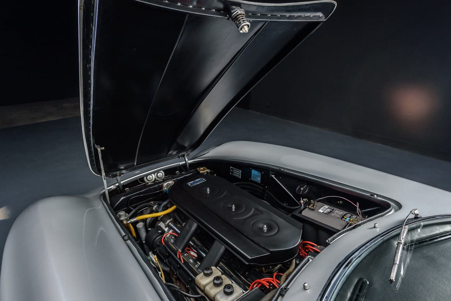 Engine bay of the 1967 Ferrari 275 GTB – Powerful V12 engine, meticulously maintained.