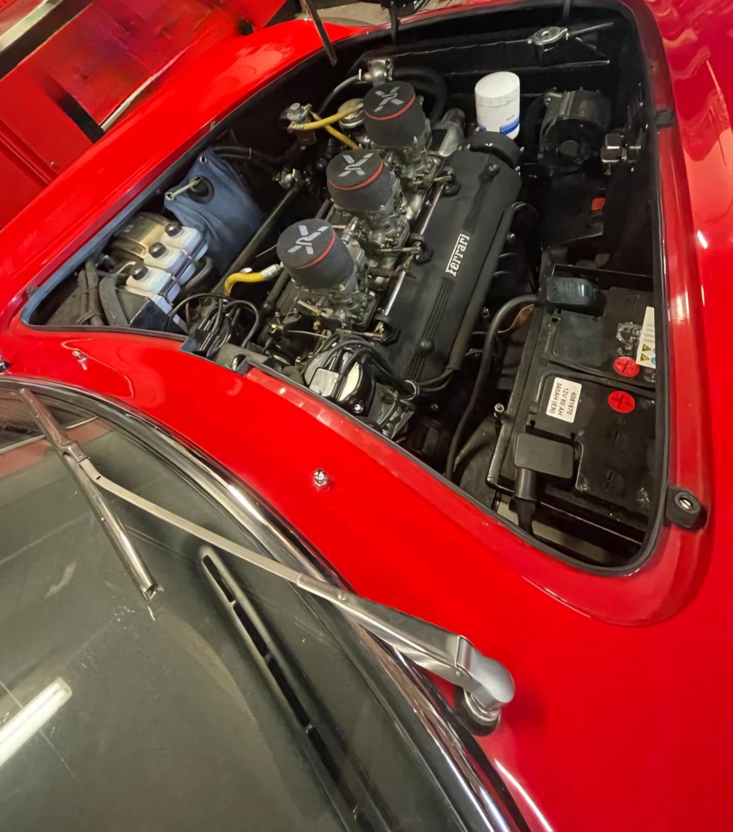 Engine bay of the 1966 Ferrari 275 GTB – Powerful V12 engine with Ferrari Classiche certification.