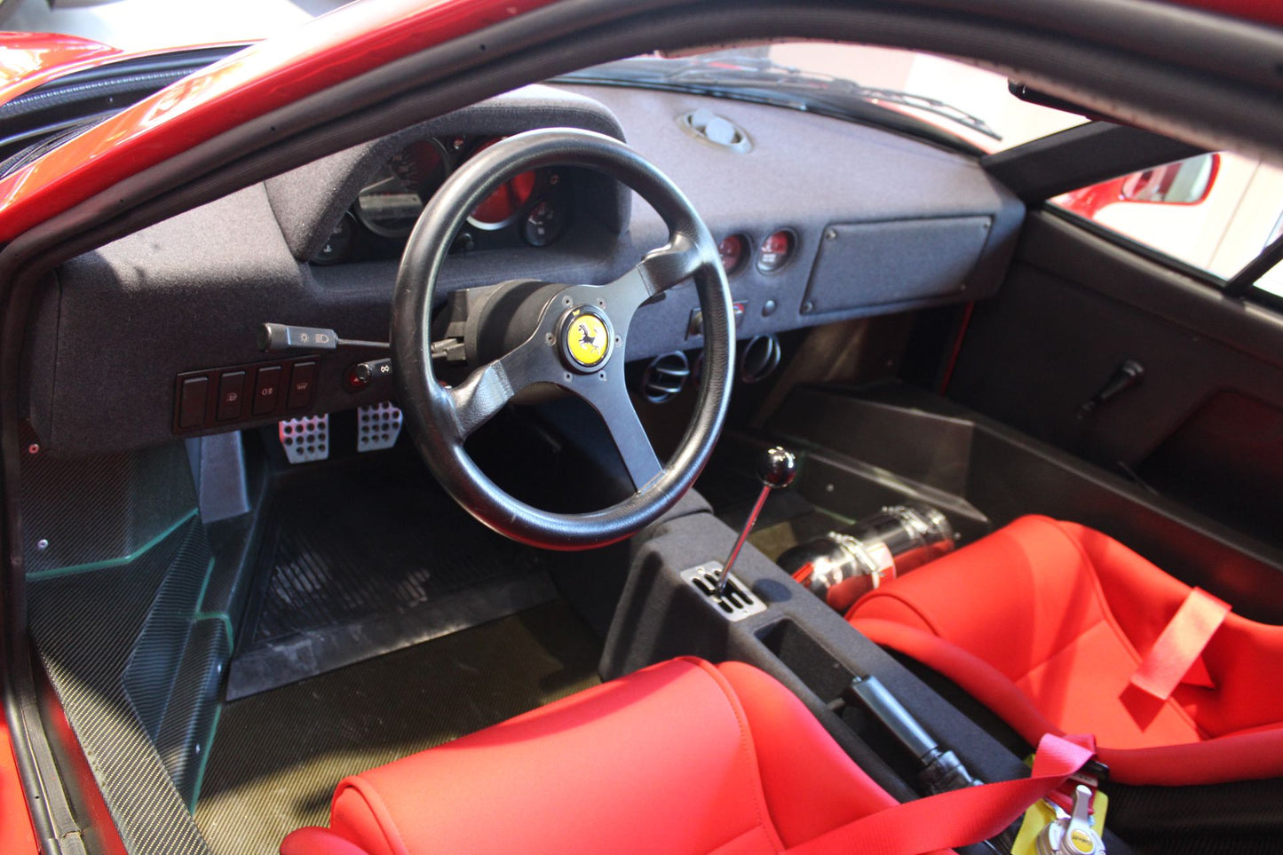 Interior of the 1990 Ferrari F40 – Race-inspired cockpit with lightweight materials and manual gearbox.