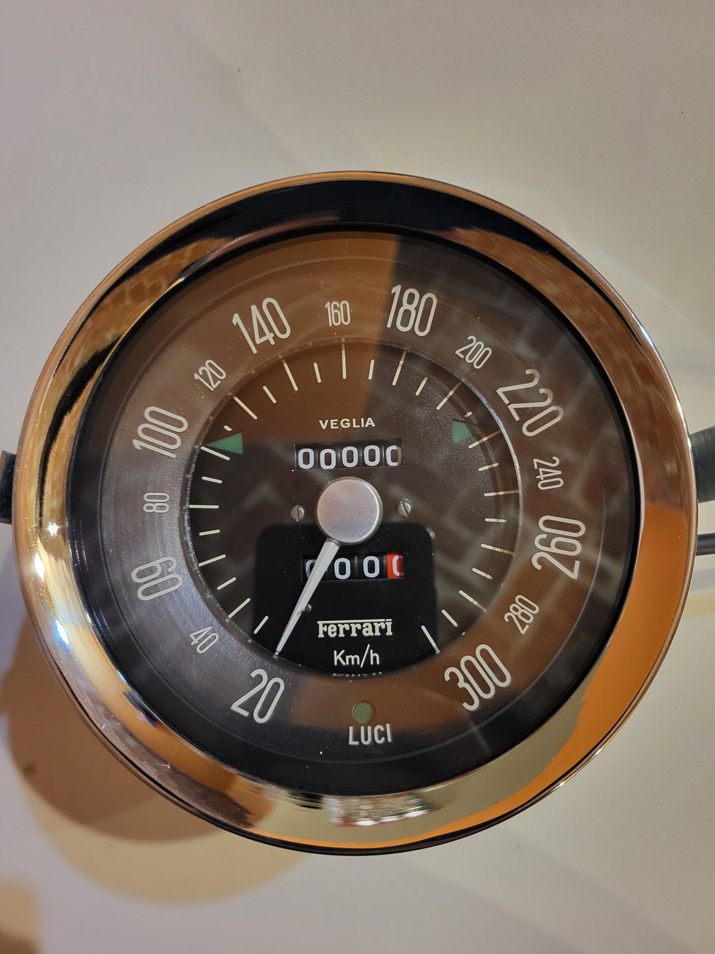 Close-up of the speedometer in a Ferrari 250 SWB, showcasing its classic design and performance metrics.