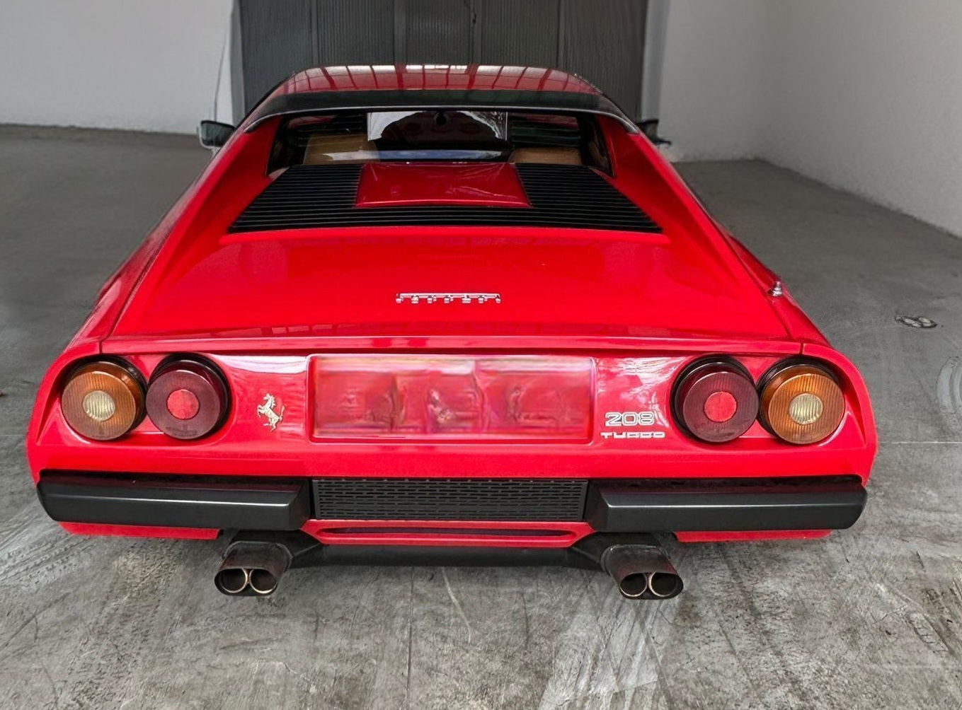 Rear view of the 1983 Ferrari 208 GTB – Classic Ferrari styling with distinctive taillights and badging.