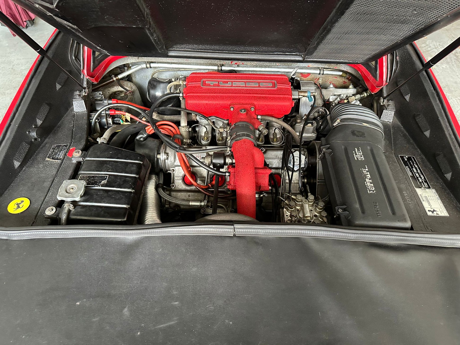 Engine bay of the 1983 Ferrari 208 GTB – Turbocharged V8 engine with Ferrari Classiche certification.